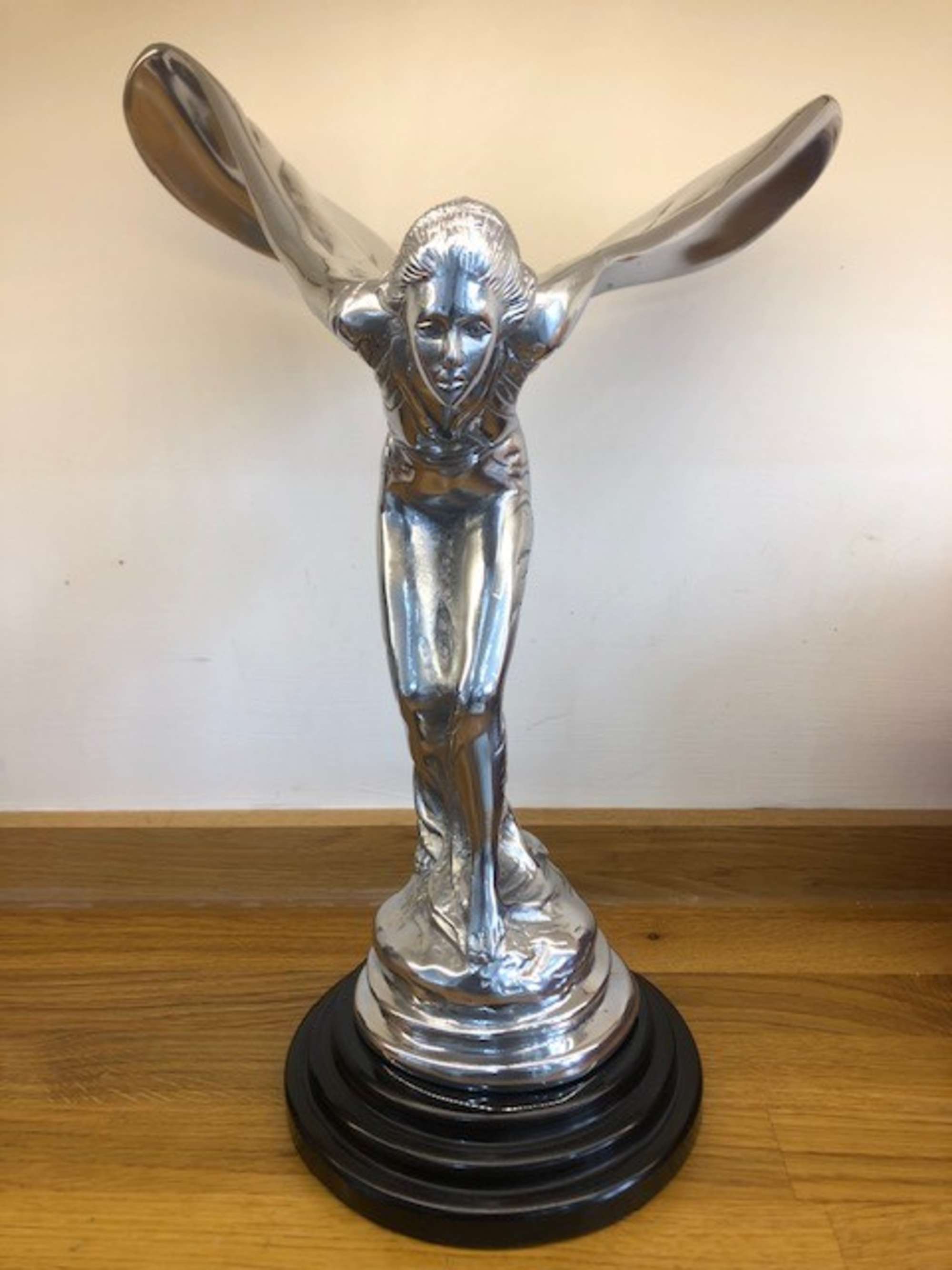 An over-sized cast metal and silvered statue of the Spirit o-Sold