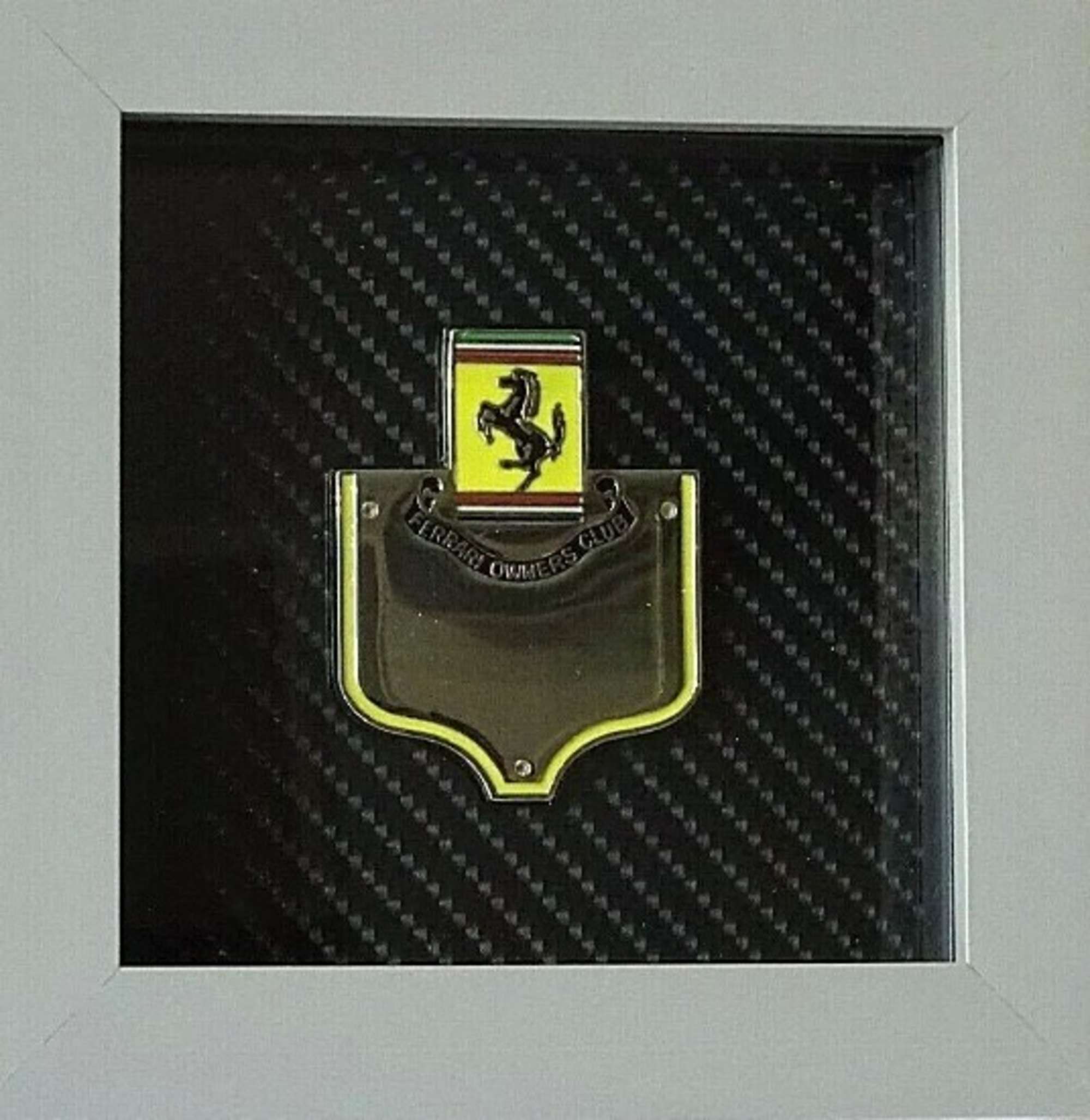An enamelled-chrome Ferrari Owners' Club grille badge mounte-Sold