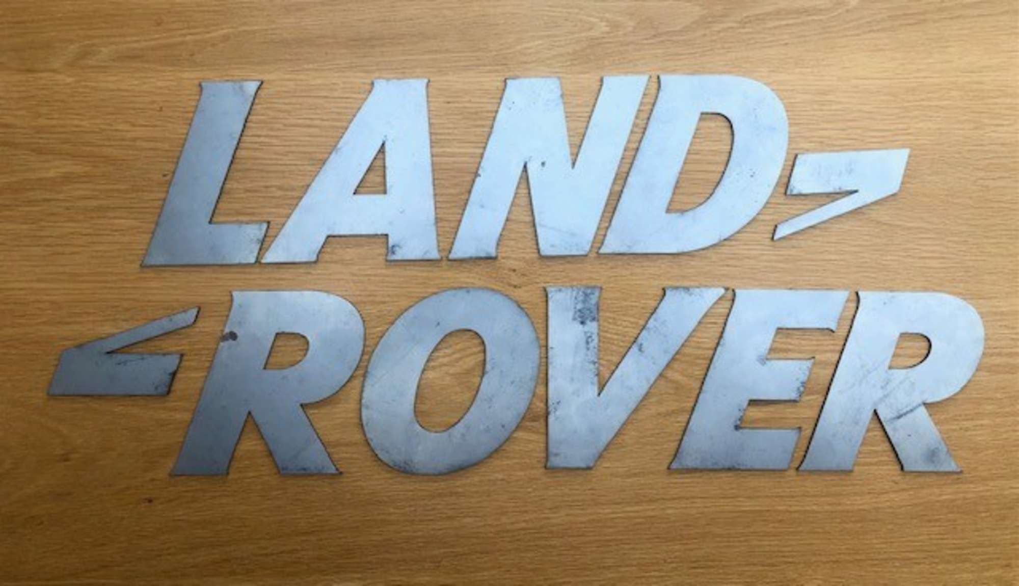 A font-correct 'Land Rover' sign in lazered-steel cut-outs-Auction Lot