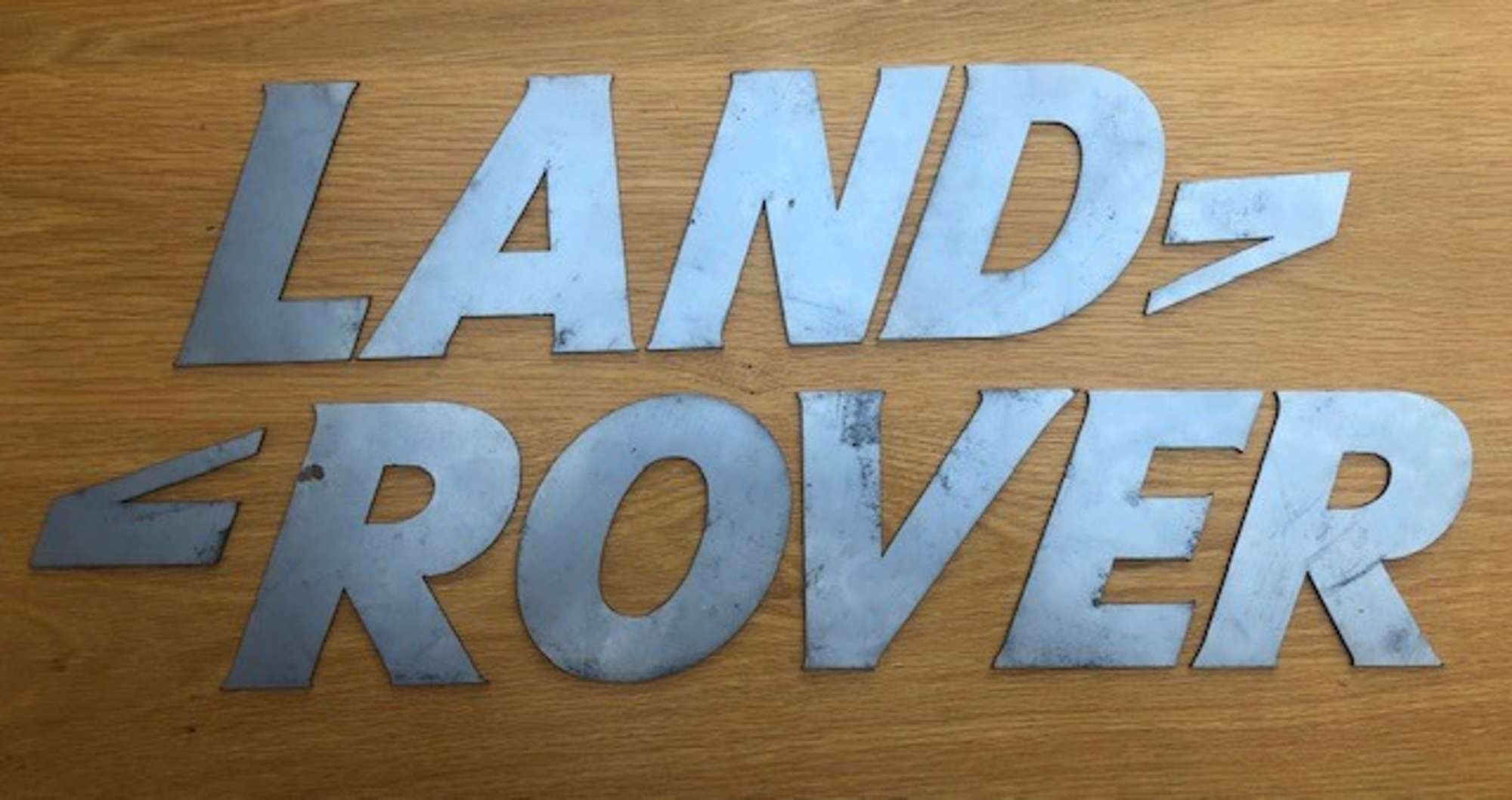 A font-correct 'Land Rover' sign in lazered-steel cut-outs-Auction Lot