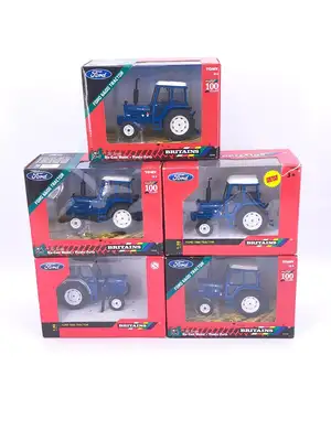 Britains, a boxed group of 1:32 scale diecast tractors. Including Ford 6600 tractors in blue livery and Ford 7600 tractor example, with duplicate issues presen