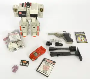 Transformers G1 collection of vintage loose action figures and accessories, featuring Metroplex with instruction booklet and assorted components, Megatron Walt