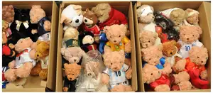 Collection of plush teddy bears, advertising football teams, hotels, etc