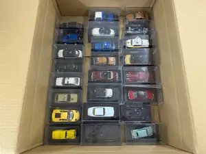 A boxed group of modern die-cast vehicles in individual clear display cases